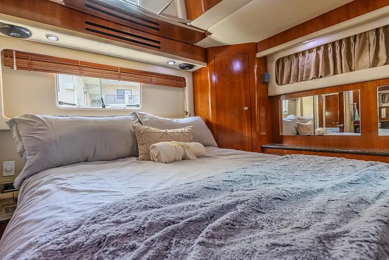 Pure Drive Yacht Photos Pics Luxurious bedroom interior of 2005 Sea Ray 390 Motor Yacht with cozy bedding.