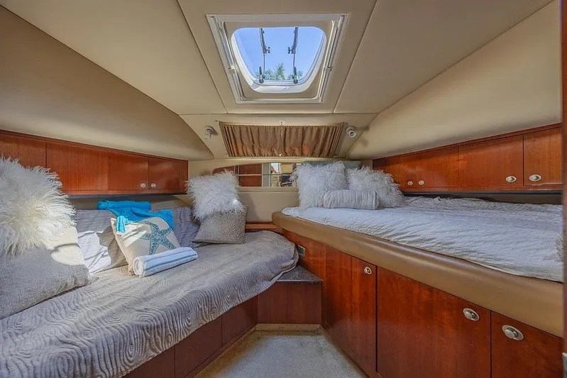 Pure Drive Yacht Photos Pics Luxurious 2005 Sea Ray 390 Motor Yacht cabin with plush bedding and elegant wood finishes.