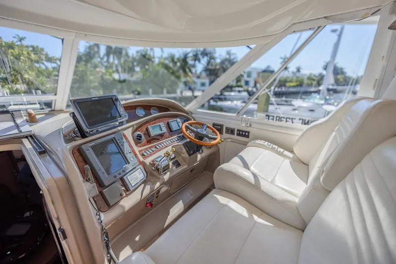 Pure Drive Yacht Photos Pics 2005 Sea Ray 390 Motor Yacht helm with modern navigation equipment and plush seating.