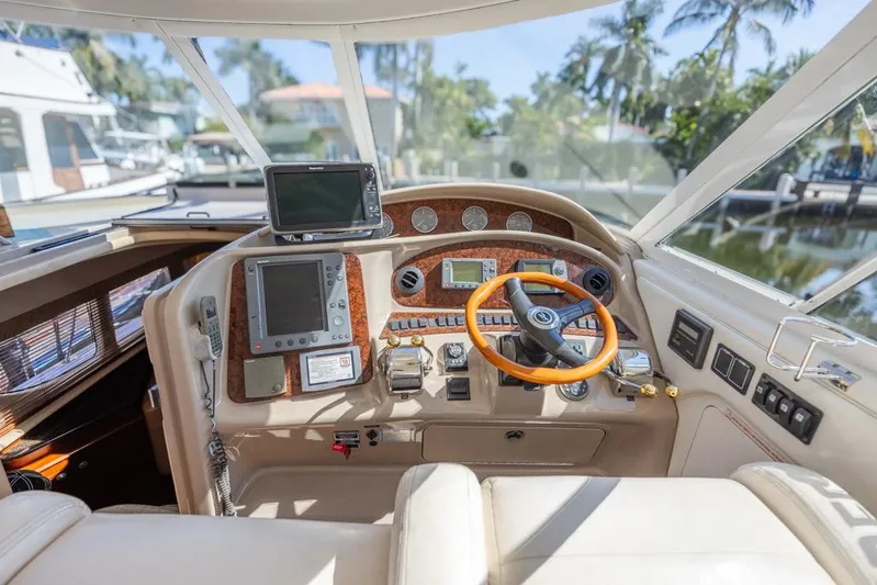 Pure Drive Yacht Photos Pics 2005 Sea Ray 390 Motor Yacht helm with modern navigation equipment and luxurious steering wheel.