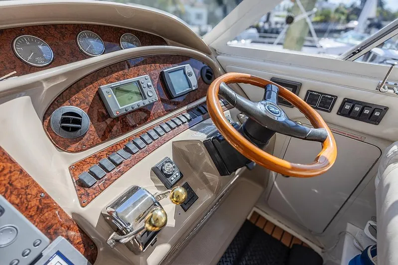 Pure Drive Yacht Photos Pics 2005 Sea Ray 390 Motor Yacht helm with wood accents and modern navigation instruments.