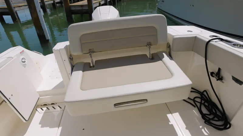  Yacht Photos Pics 2023 Boston Whaler 240 Vantage boat seat, beige upholstery, docked in marina.