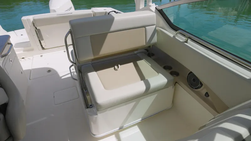  Yacht Photos Pics 2023 Boston Whaler 240 Vantage boat interior with cushioned seating and storage.