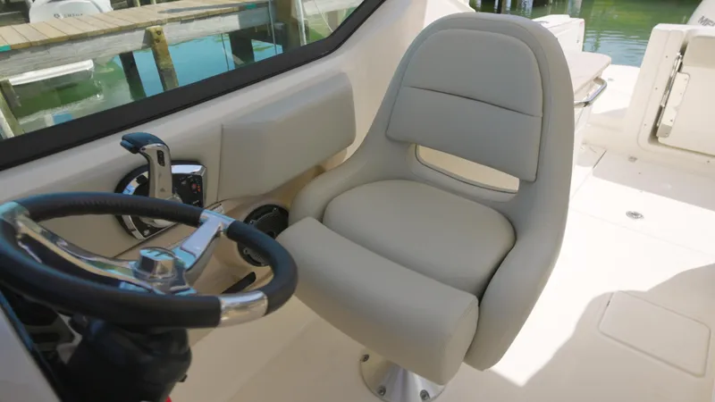 Yacht Photos Pics 2023 Boston Whaler 240 Vantage helm seat and steering wheel, showcasing luxury and comfort.