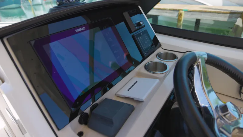  Yacht Photos Pics Helm of 2023 Boston Whaler 240 Vantage with modern navigation equipment and cup holders.