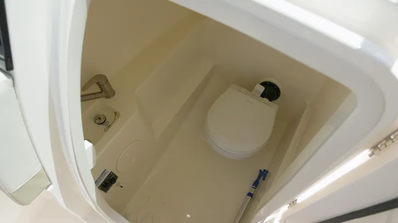  Yacht Photos Pics 2023 Boston Whaler 240 Vantage boat interior with compact marine toilet.
