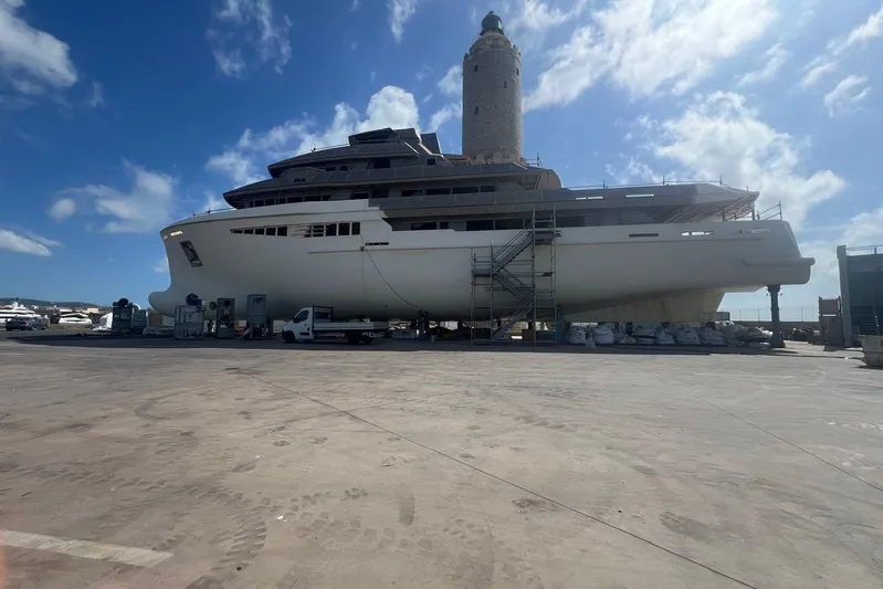  Yacht Photos Pics Large custom yacht under construction at shipyard, 2026 model, with scaffolding and clear blue sky.