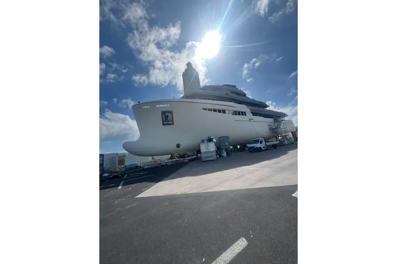  Yacht Photos Pics Large custom yacht under construction, 2026 model, with clear blue sky and sunlight.