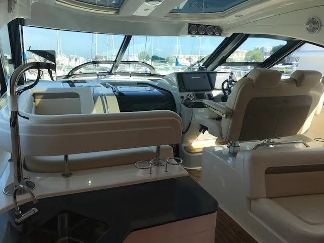 My Marilyn Yacht Photos Pics Interior of 2013 Sea Ray 470 Sundancer yacht with helm and seating area.