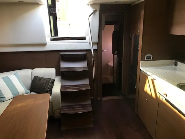 My Marilyn Yacht Photos Pics Interior of 2013 Sea Ray 470 Sundancer yacht with stairs, seating, and kitchenette.