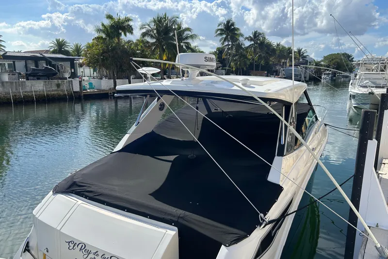  Yacht Photos Pics 2022 Sea Ray Sundancer 320 Outboard docked in a scenic canal setting.
