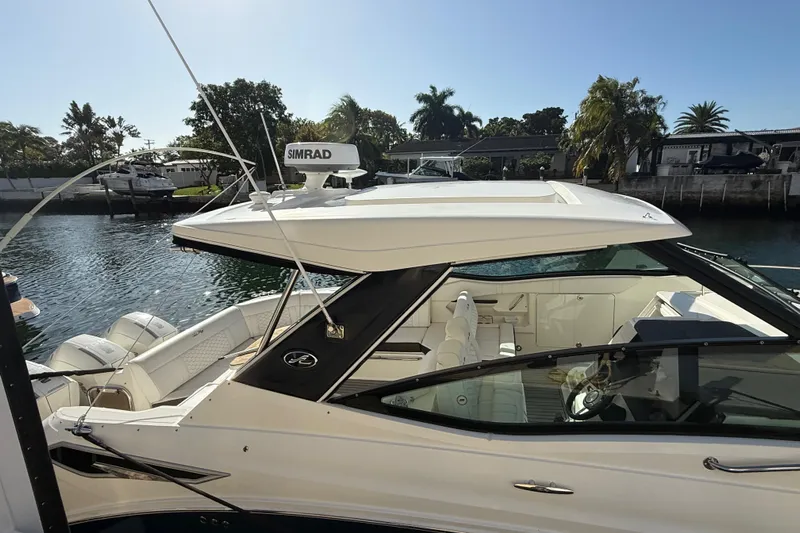  Yacht Photos Pics 2022 Sea Ray Sundancer 320 Outboard docked, showcasing sleek design and luxurious interior.