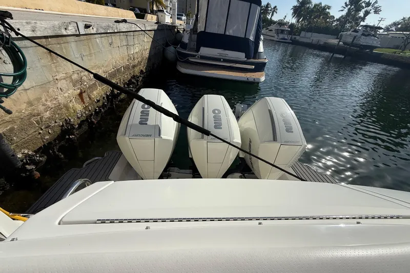  Yacht Photos Pics 2022 Sea Ray Sundancer 320 Outboard with triple Mercury engines docked in marina.