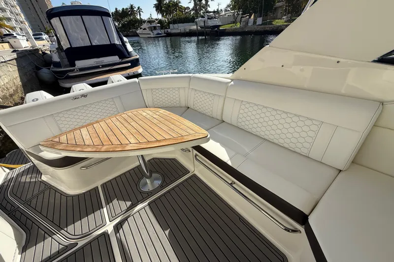  Yacht Photos Pics 2022 Sea Ray Sundancer 320 Outboard interior with elegant seating and wooden table.