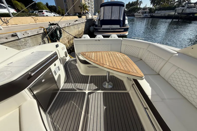  Yacht Photos Pics 2022 Sea Ray Sundancer 320 Outboard interior with elegant seating and wooden table.