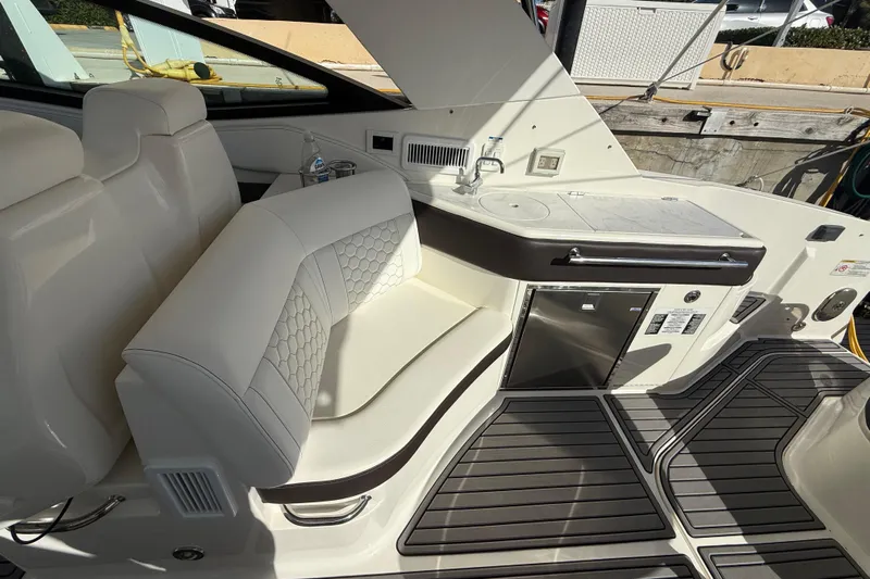  Yacht Photos Pics Luxurious interior of 2022 Sea Ray Sundancer 320 Outboard with seating and kitchenette.
