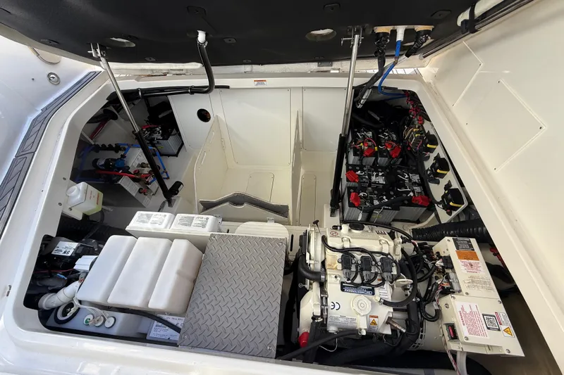  Yacht Photos Pics Engine compartment of 2022 Sea Ray Sundancer 320 Outboard, showcasing mechanical components and battery setup.