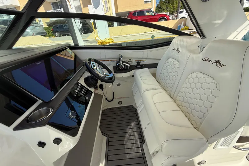  Yacht Photos Pics 2022 Sea Ray Sundancer 320 Outboard cockpit with luxurious white seating and modern controls.