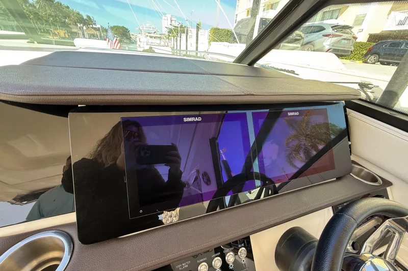  Yacht Photos Pics 2022 Sea Ray Sundancer 320 Outboard dashboard with Simrad display and steering wheel.