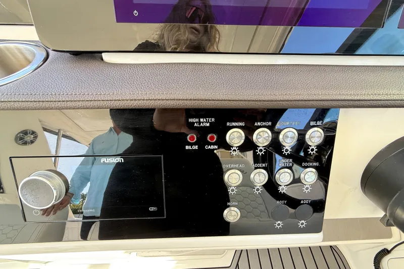  Yacht Photos Pics Control panel of 2022 Sea Ray Sundancer 320 Outboard with various switches and a Fusion audio system.