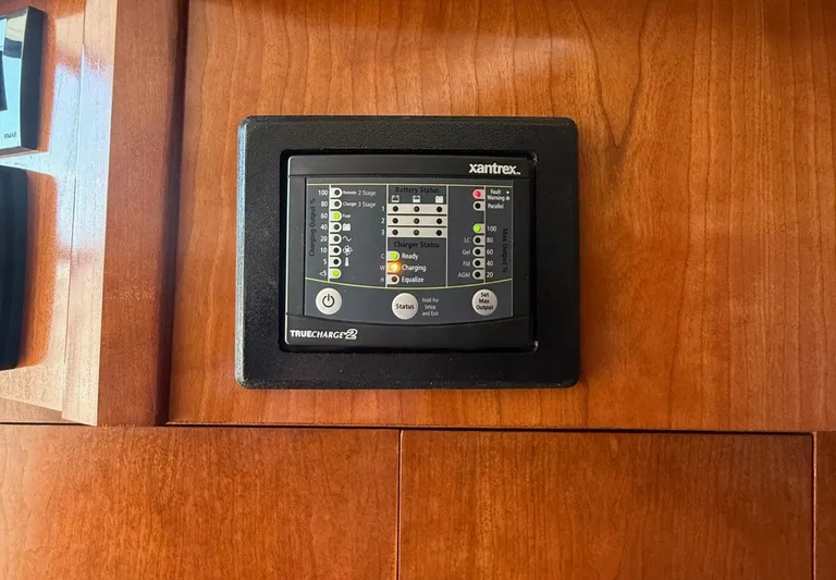 Ciel Rouge Yacht Photos Pics Xantrex TrueCharge2 panel on 2006 Cruisers Yachts 420 Express, mounted on wooden surface.
