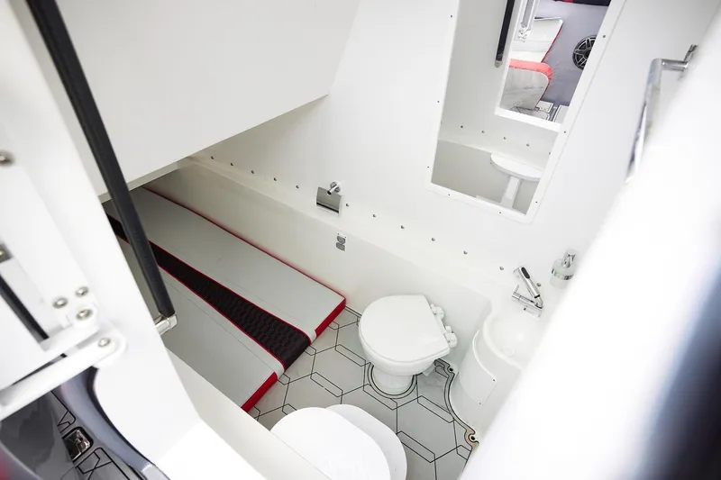  Yacht Photos Pics 2025 Midnight Express 37' Open boat interior with compact bathroom and sleeping area.