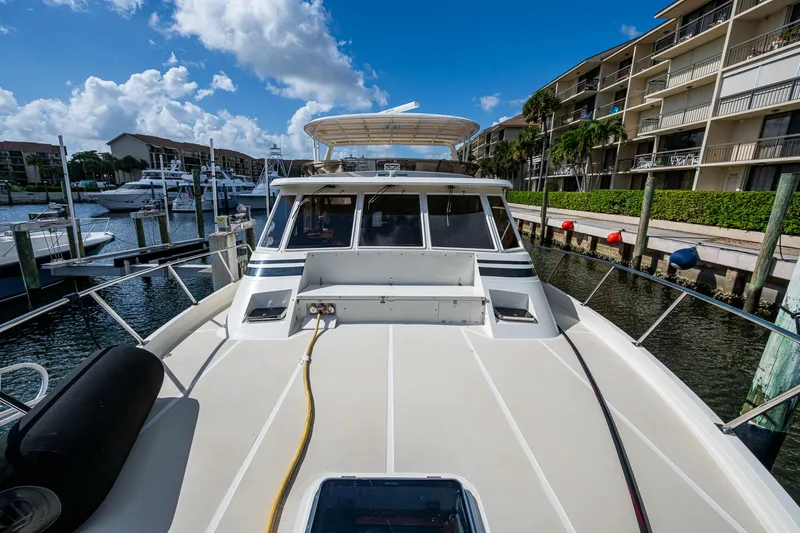  Yacht Photos Pics 2000 Offshore Yachts 58 Pilot House docked at marina under blue sky.