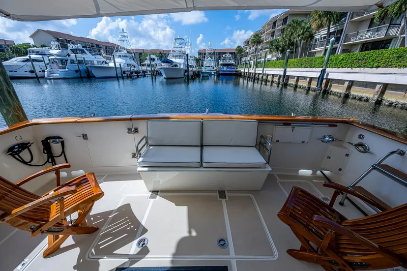  Yacht Photos Pics 2000 Offshore Yachts 58 Pilot House, spacious deck with seating, overlooking marina.