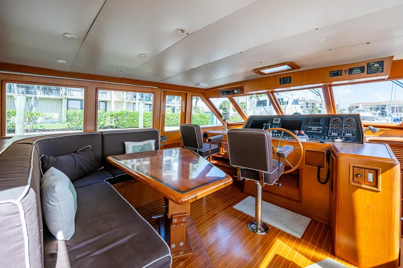  Yacht Photos Pics Luxurious interior of 2000 Offshore Yachts 58 Pilot House with wood finishes and seating area.