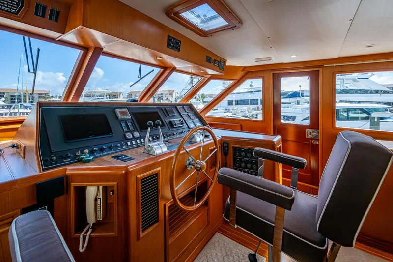  Yacht Photos Pics 2000 Offshore Yachts 58 Pilot House helm with wooden interior and modern navigation equipment.