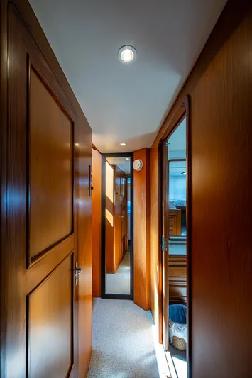  Yacht Photos Pics Interior hallway of 2000 Offshore Yachts 58 Pilot House with wooden paneling and carpet flooring.