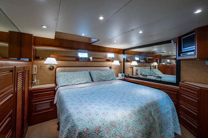  Yacht Photos Pics Luxurious bedroom in 2000 Offshore Yachts 58 Pilot House with elegant wood finishes.