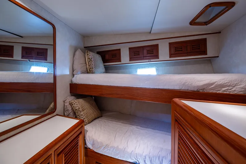  Yacht Photos Pics Bunk beds in 2000 Offshore Yachts 58 Pilot House cabin with wooden accents and mirror.