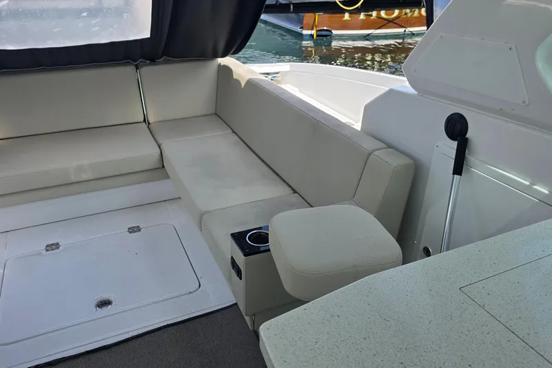 Yacht Photos Pics 2017 Monterey 360 Sport Coupe interior with beige seating and cup holder.