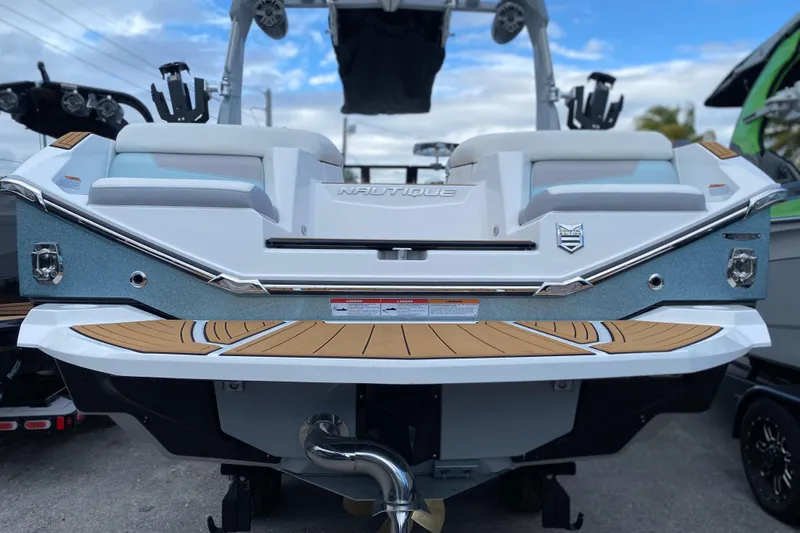  Yacht Photos Pics 2022 Nautique Super Air Nautique G23 Coastal Edition boat rear view with teak deck.