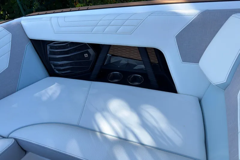  Yacht Photos Pics 2022 Nautique Super Air Nautique G23 Coastal Edition interior seating with speaker and cup holders.