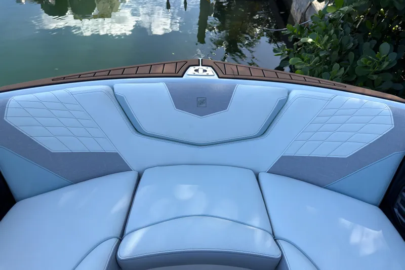  Yacht Photos Pics 2022 Nautique Super Air Nautique G23 Coastal Edition boat interior with blue upholstery.