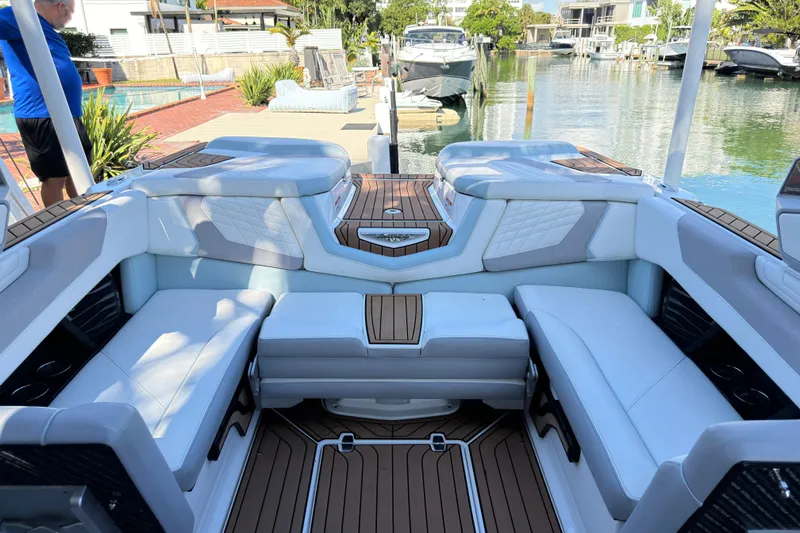  Yacht Photos Pics 2022 Nautique Super Air Nautique G23 Coastal Edition interior with luxurious seating and elegant design.
