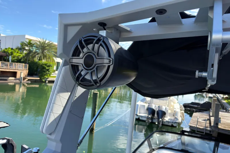  Yacht Photos Pics 2022 Nautique Super Air Nautique G23 Coastal Edition speaker on a boat, dockside view.
