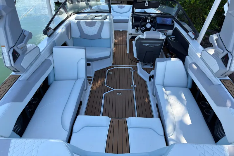  Yacht Photos Pics 2022 Nautique Super Air Nautique G23 Coastal Edition interior with luxurious seating and modern dashboard.