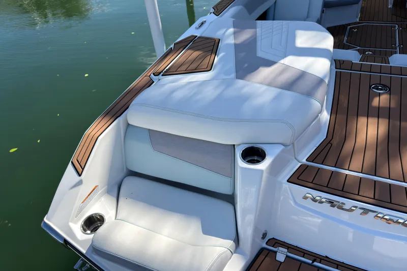  Yacht Photos Pics 2022 Nautique Super Air Nautique G23 Coastal Edition boat interior with cushioned seating.