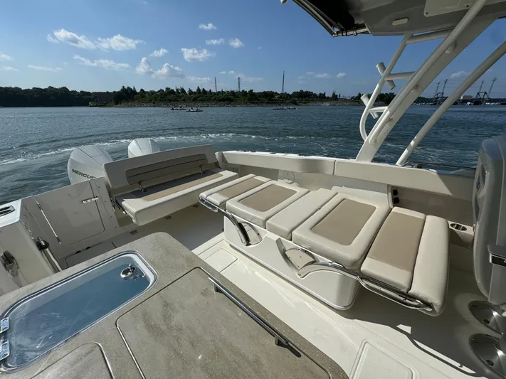  Yacht Photos Pics 2023 Boston Whaler 320 Vantage boat interior with seating and water view.