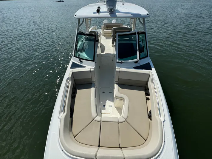  Yacht Photos Pics 2023 Boston Whaler 320 Vantage boat on water, featuring spacious seating and sleek design.