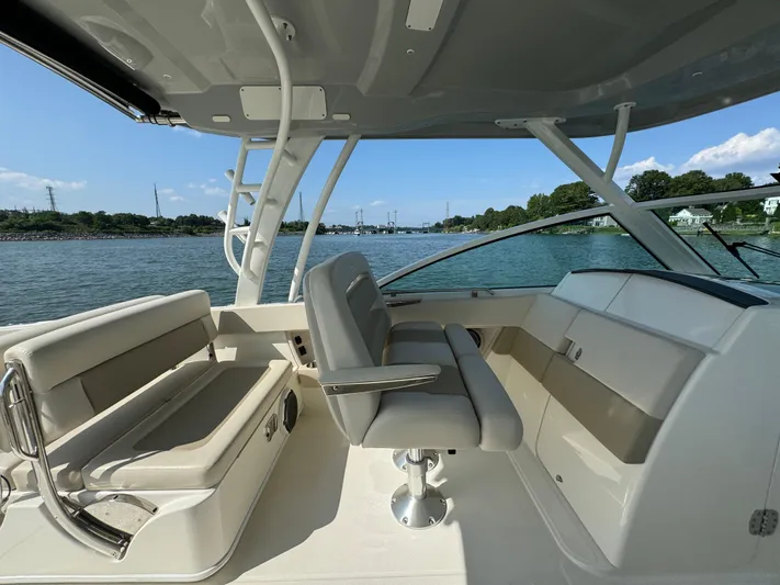  Yacht Photos Pics 2023 Boston Whaler 320 Vantage interior with seating, overlooking calm waters and shoreline.