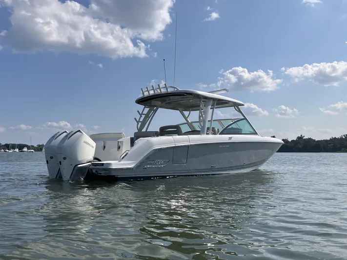  Yacht Photos Pics 2023 Boston Whaler 320 Vantage boat on calm water under a blue sky.