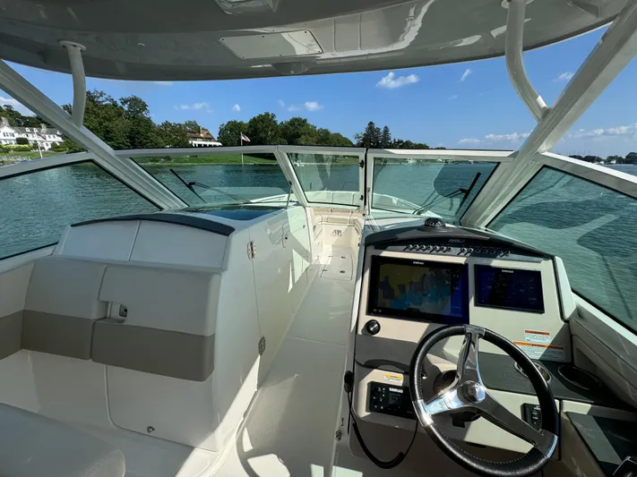  Yacht Photos Pics 2023 Boston Whaler 320 Vantage boat interior with modern dashboard and scenic water view.