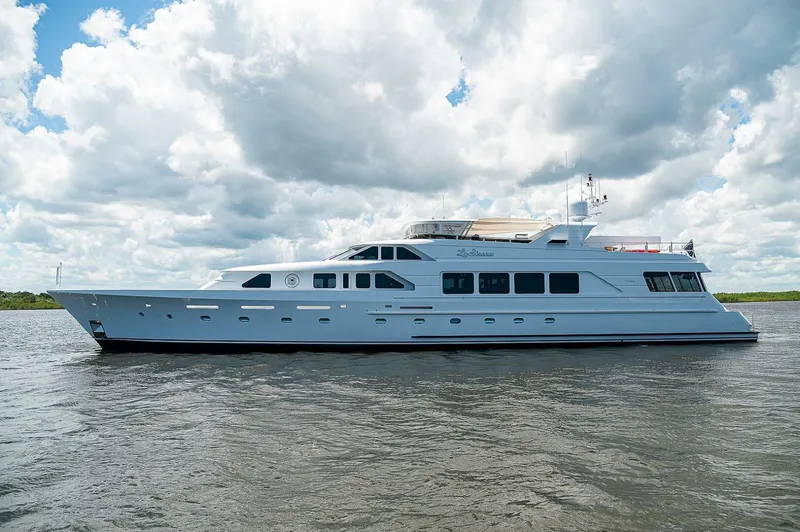La Sirena Yacht Photos Pics Luxurious 2000 Christensen 141 Raised Pilothouse yacht cruising under cloudy skies.