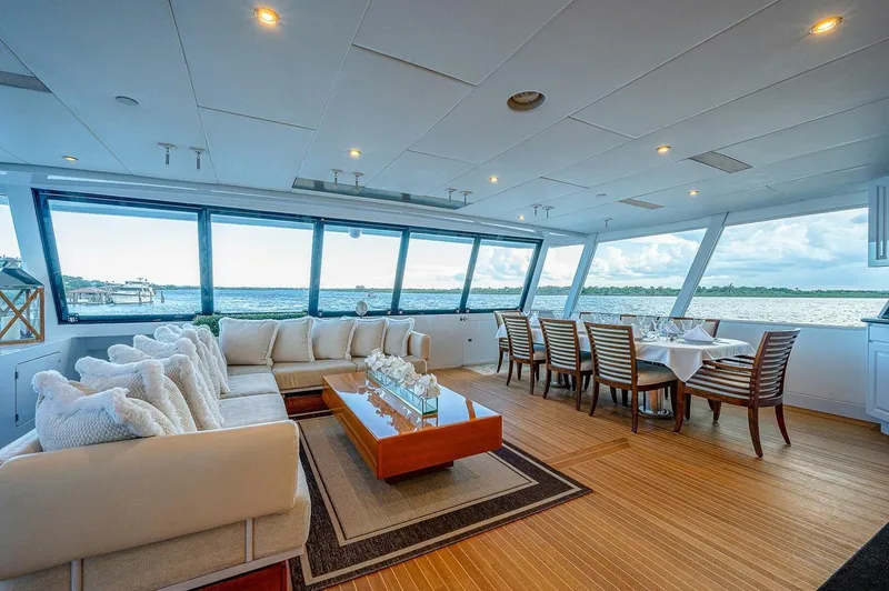 La Sirena Yacht Photos Pics Luxurious interior of 2000 Christensen 141 Raised Pilothouse yacht with elegant seating and dining area.