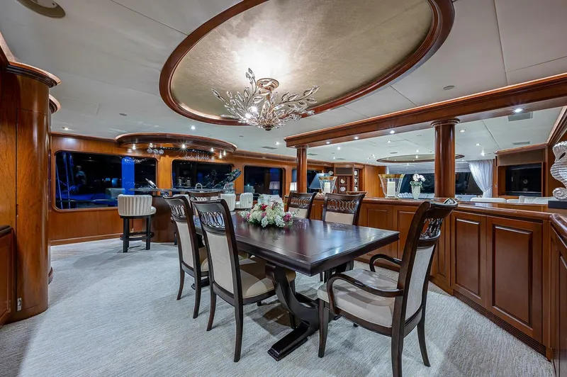 La Sirena Yacht Photos Pics Luxurious dining area on 2000 Christensen 141 Raised Pilothouse yacht, elegant wood finishes.