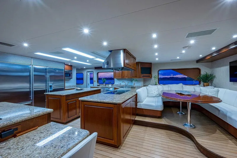 La Sirena Yacht Photos Pics Luxurious interior of 2000 Christensen 141 Raised Pilothouse yacht with modern kitchen and seating area.